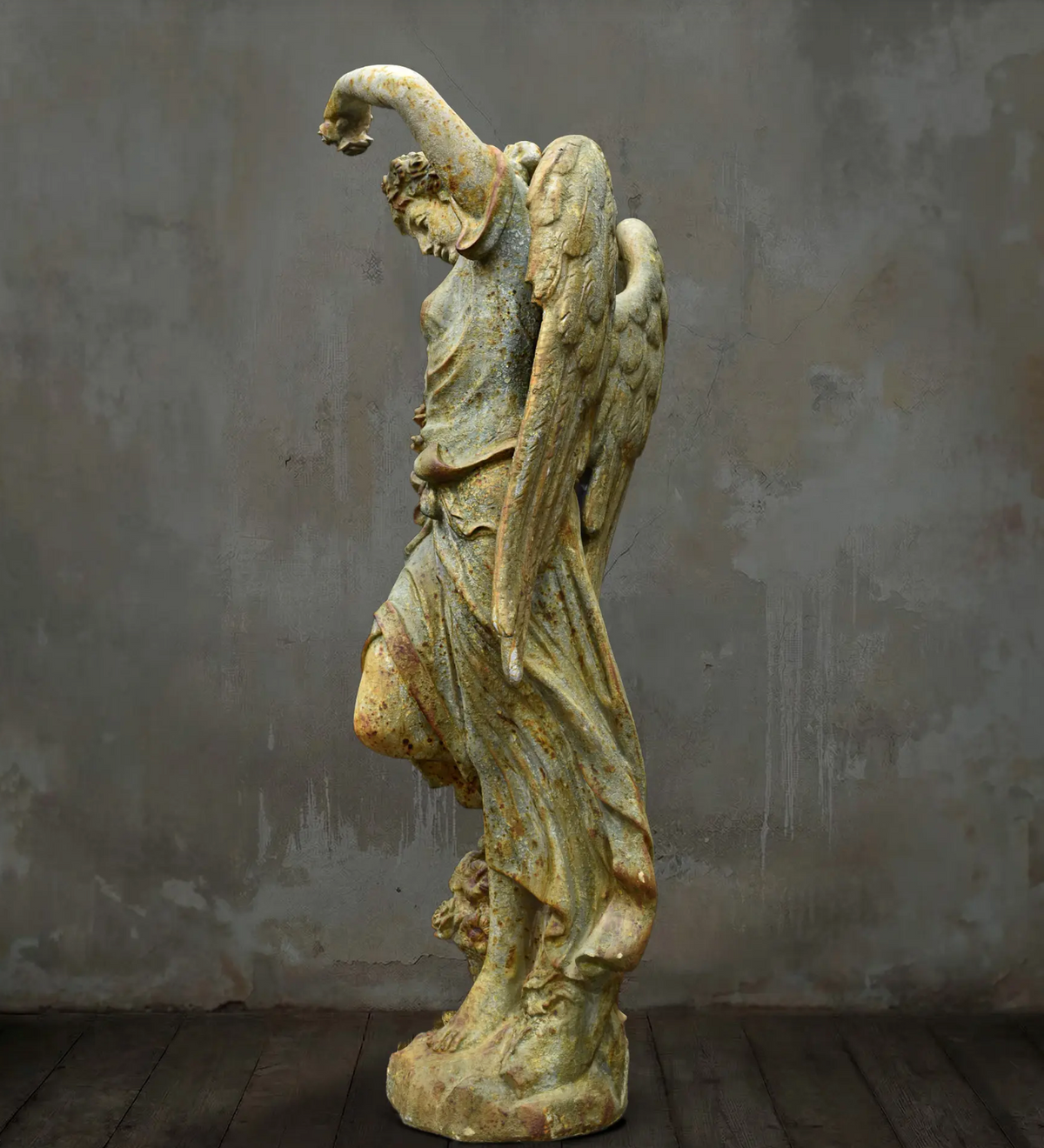 Rear view of angel statue with two feathered wings