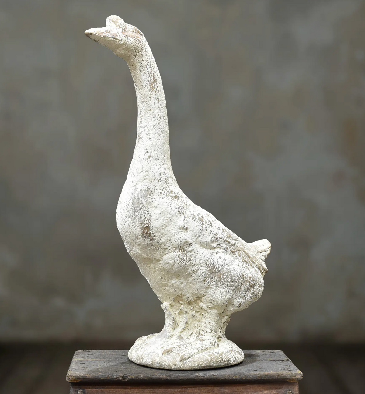 Standing goose statue with upright neck and weathered off-white finish