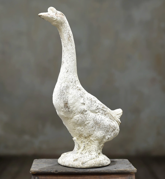Standing goose statue with upright neck and weathered off-white finish