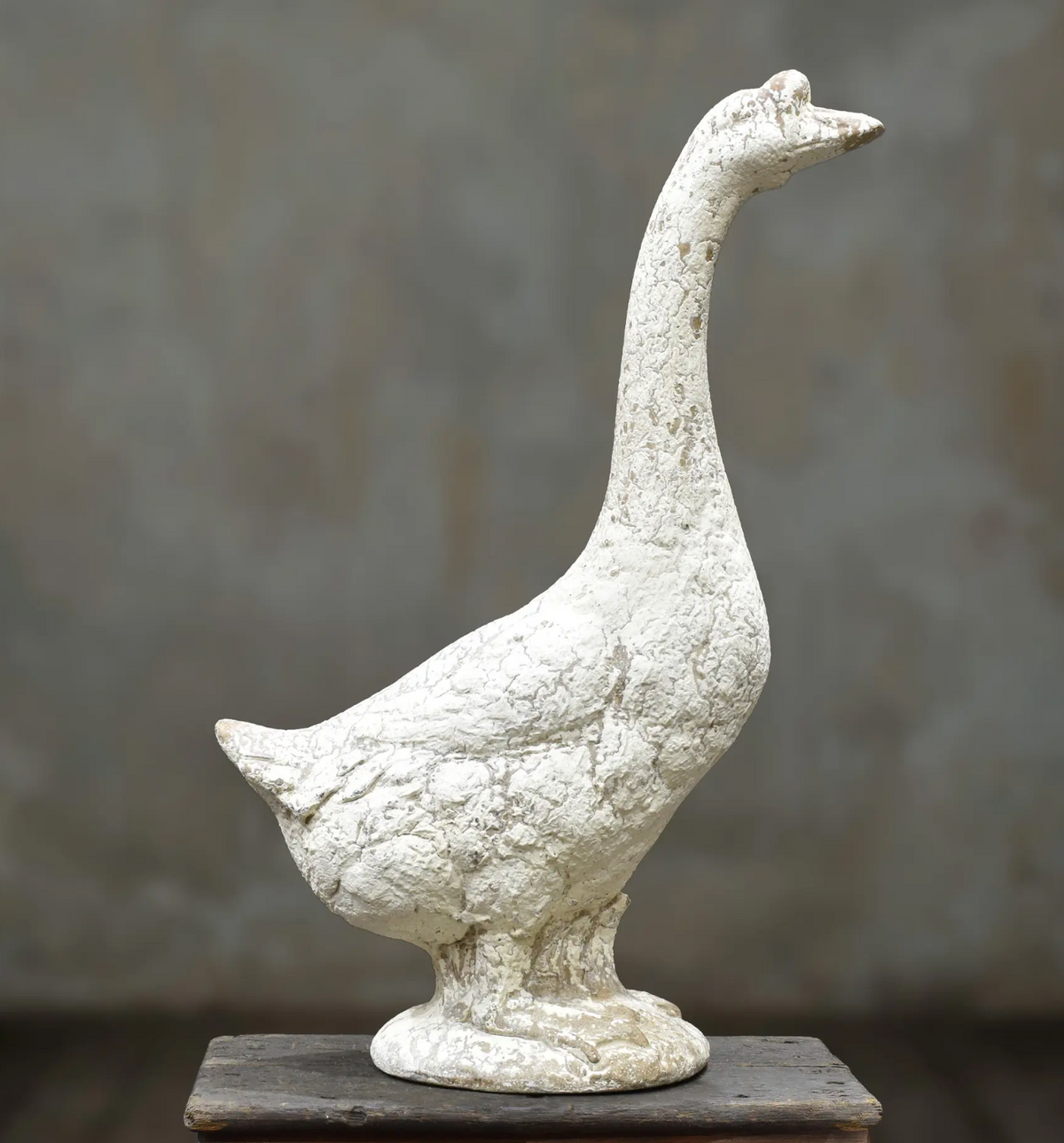 Close-up of goose statue head and beak with aged stone-effect finish