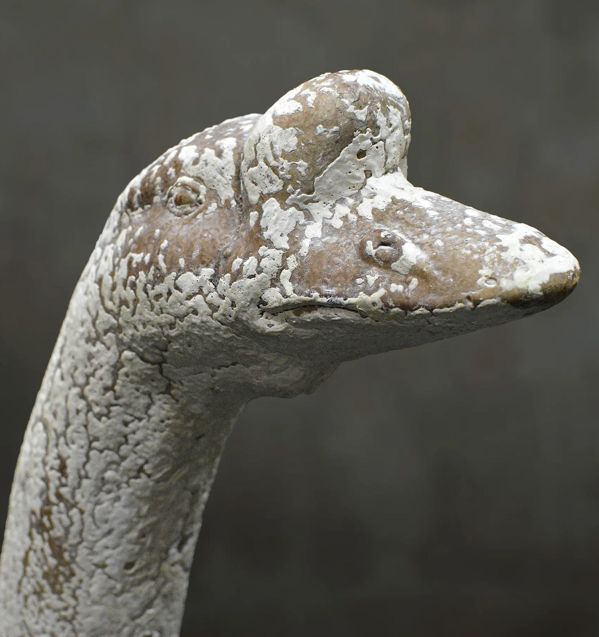 Angled view of standing goose statue with textured weathered finish