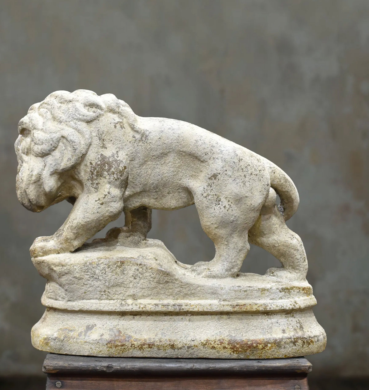 Opposite side of the lion statue showing its mane and standing pose