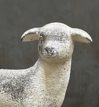 Close-up of the lamb statue's face, outstretched ears and textured fleece