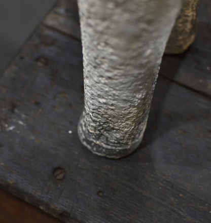 Close-up of the lamb statue's leg and hoof showing the weathered painted finish