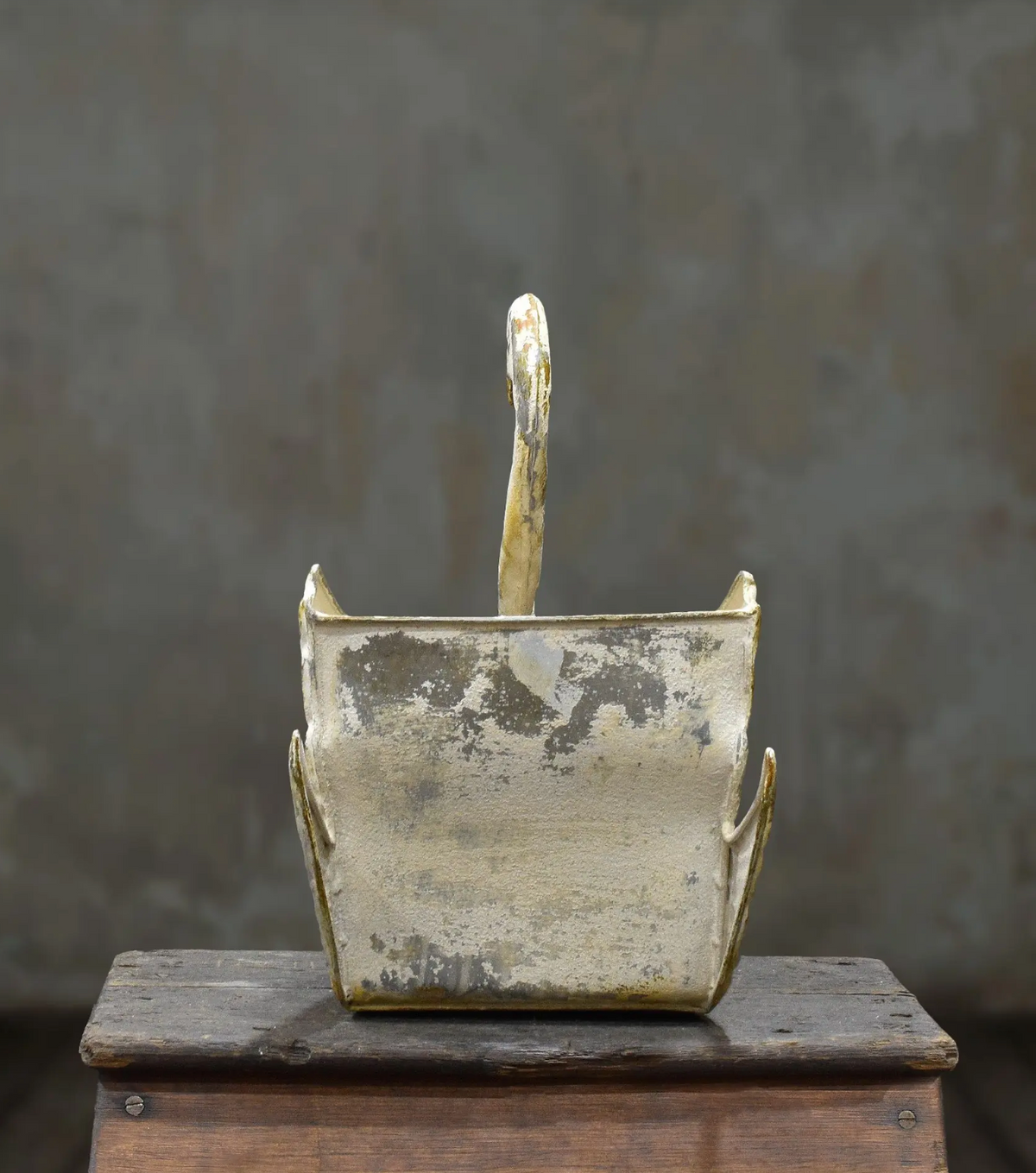 Rear view of the tin swan planter showing its open body and raised wings