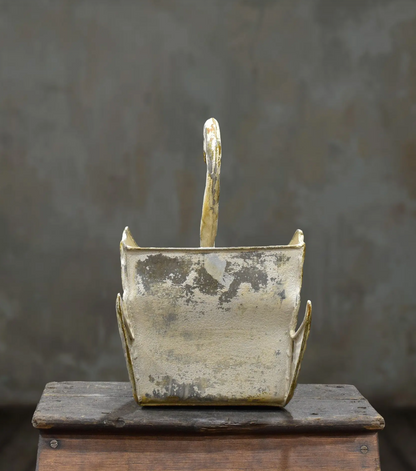 Rear view of the tin swan planter showing its open body and raised wings