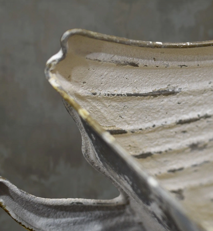 Close-up of the tin swan planter's open rim and aged finish