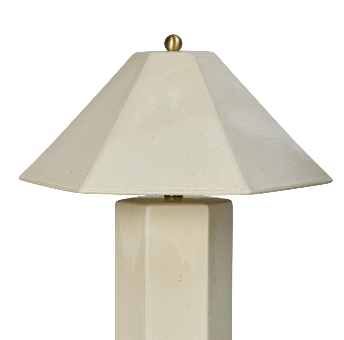 Close-up of the ivory lamp's angled shade and brass finial