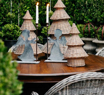 Willow Christmas trees arranged with metal angel decorations and candles