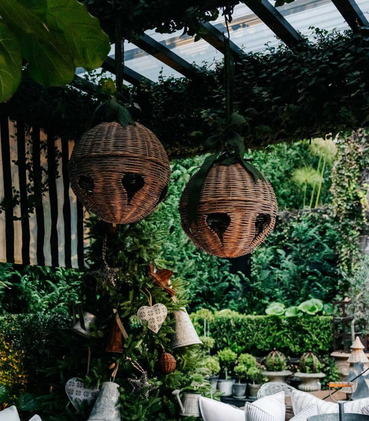 Two round willow bells hanging above a seasonal display