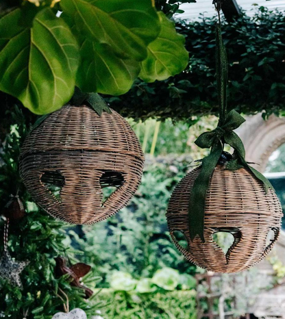 Willow bell decorations suspended beside festive greenery