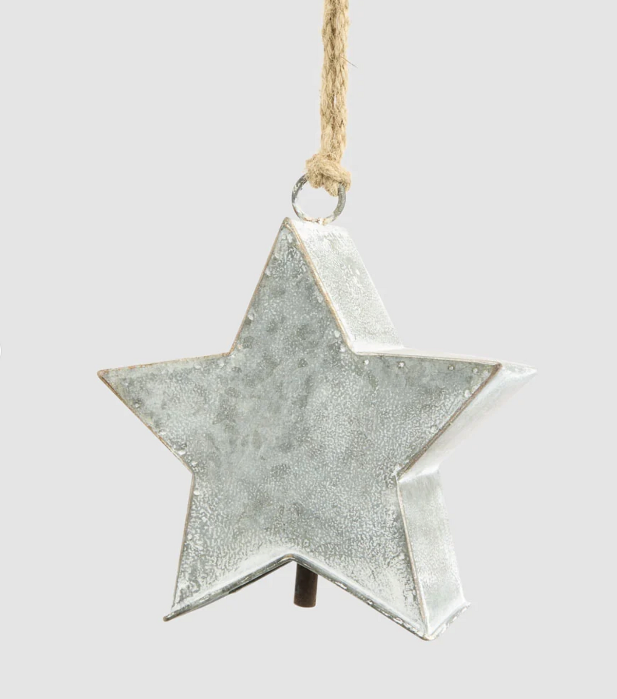 Close-up of zinc star decoration showing its dimensional shape and mottled finish