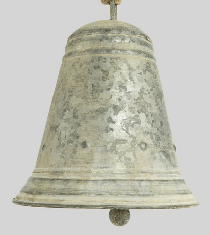 Close-up of flared zinc bell showing raised bands, mottled surface and clapper