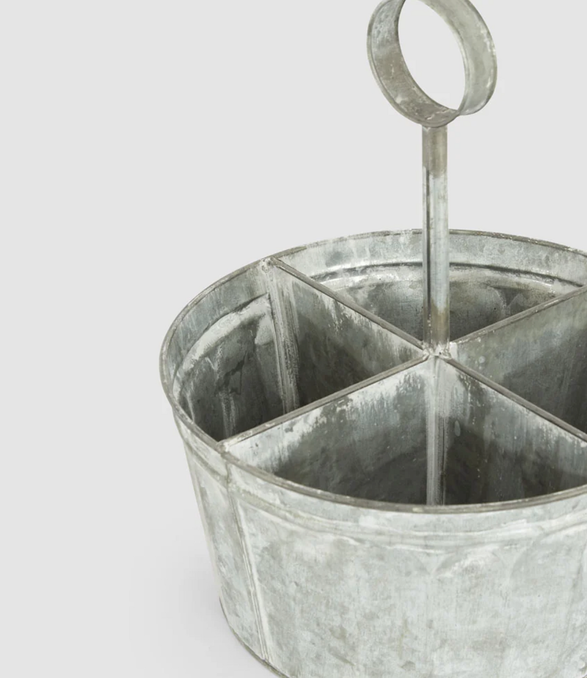 Close-up of zinc cutlery caddy compartments and ring handle