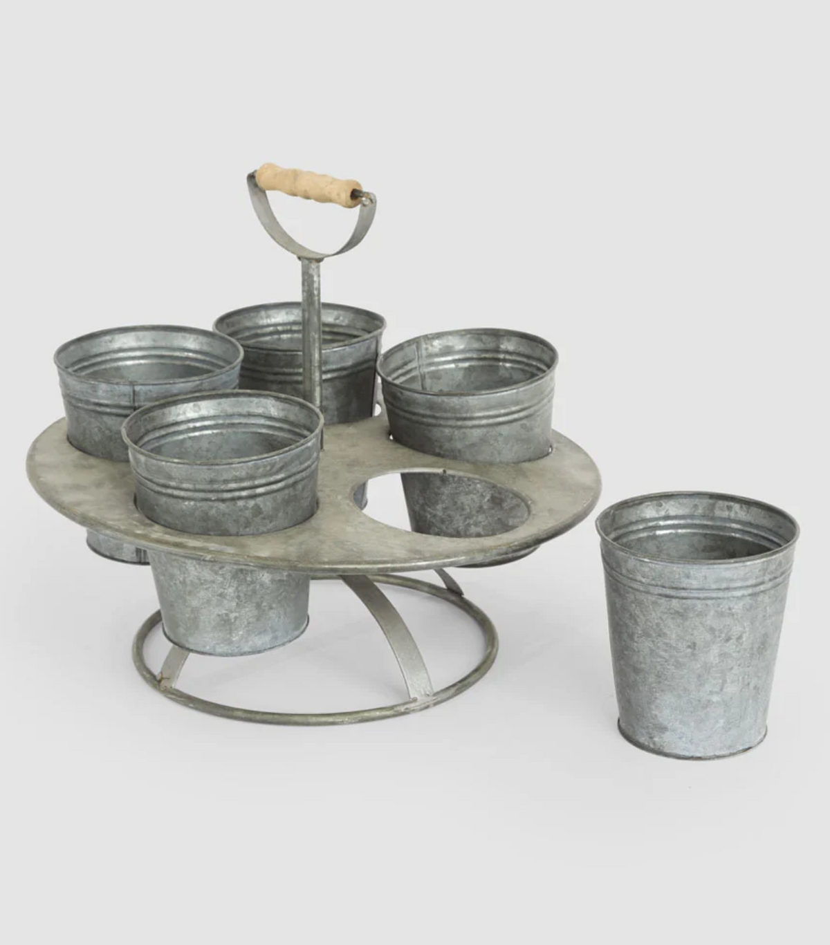 Close-up of seedling pots and central handle in galvanised metal holder