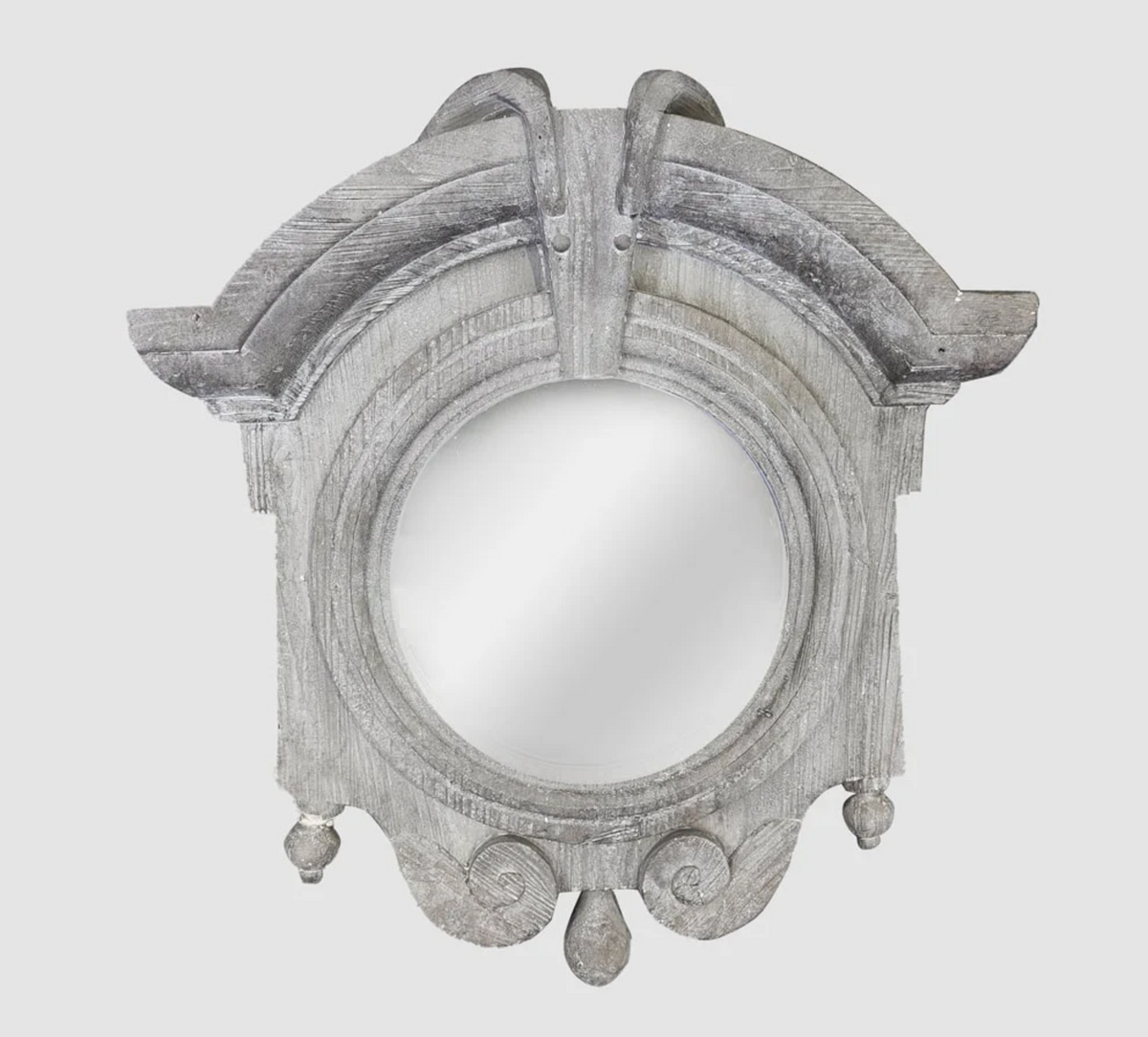 Mirror with a circular glass centre and textured grey zinc-finished frame, arched crest, scroll details and hanging teardrop ornaments.