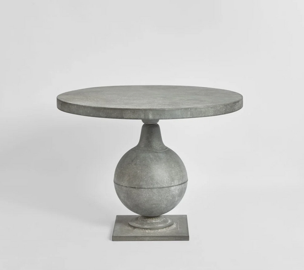 Zinc finish round table with curved pedestal base and square foot, front view