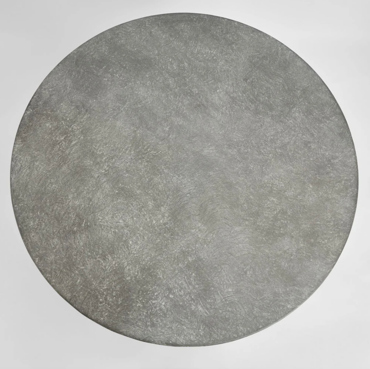Overhead view of the round tabletop showing the mottled grey zinc finish