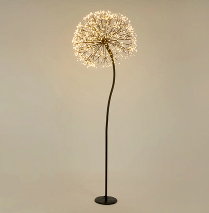 Dandelion floor light illuminated with warm white LEDs on a curved black stem and round base