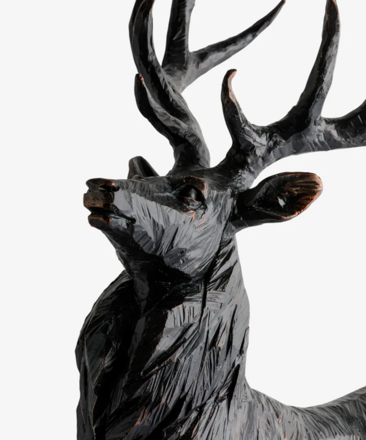 Close-up of the black stag sculpture showing its raised head, antlers and textured coat
