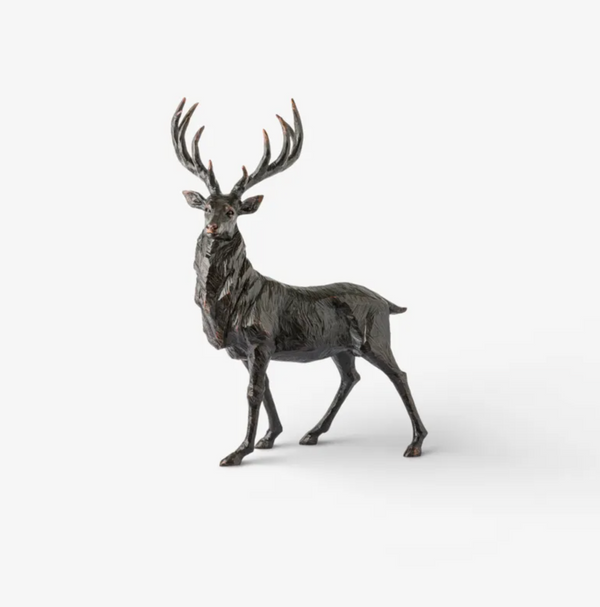 Antique black standing stag sculpture with its head turned and branching antlers