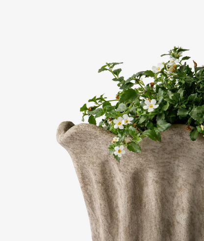 Terra Fluted Oval Planter Large in sand terracotta with a flowering plant