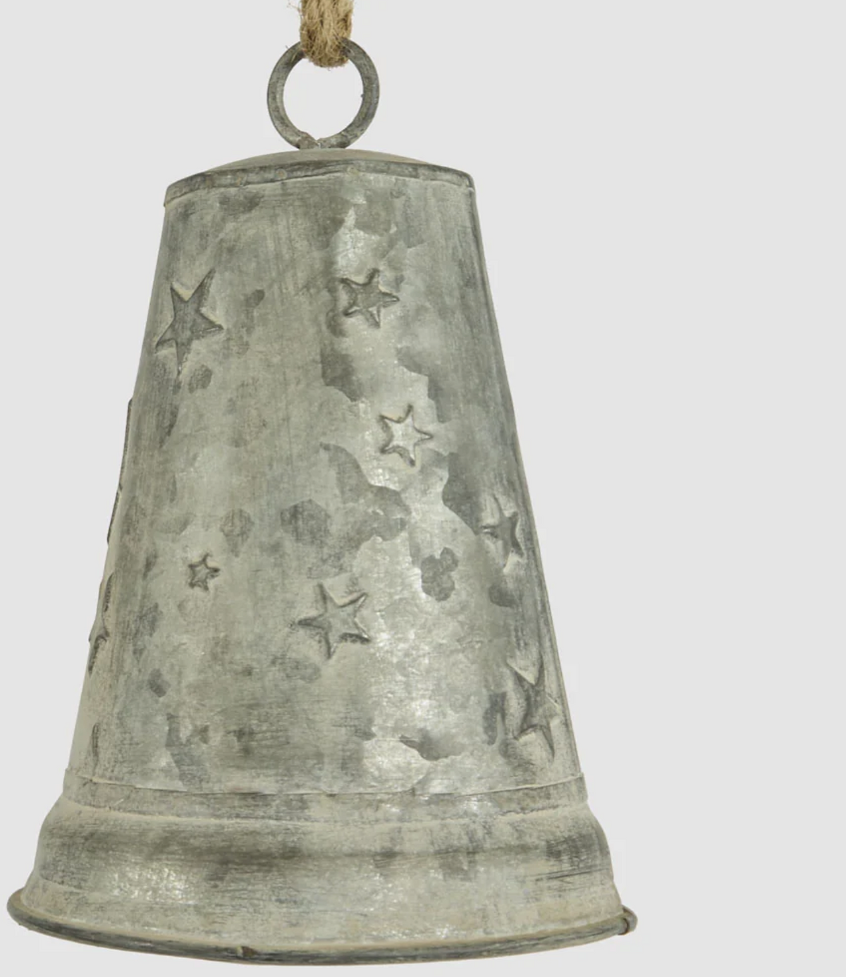 Close-up of small zinc bell showing stars and silver-grey finish