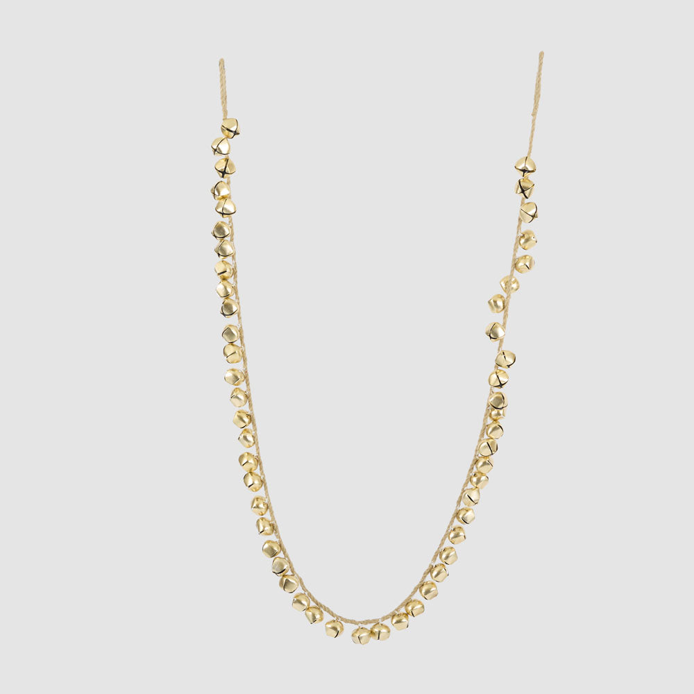 Gold bell garland hanging in a curved shape from two cord loops