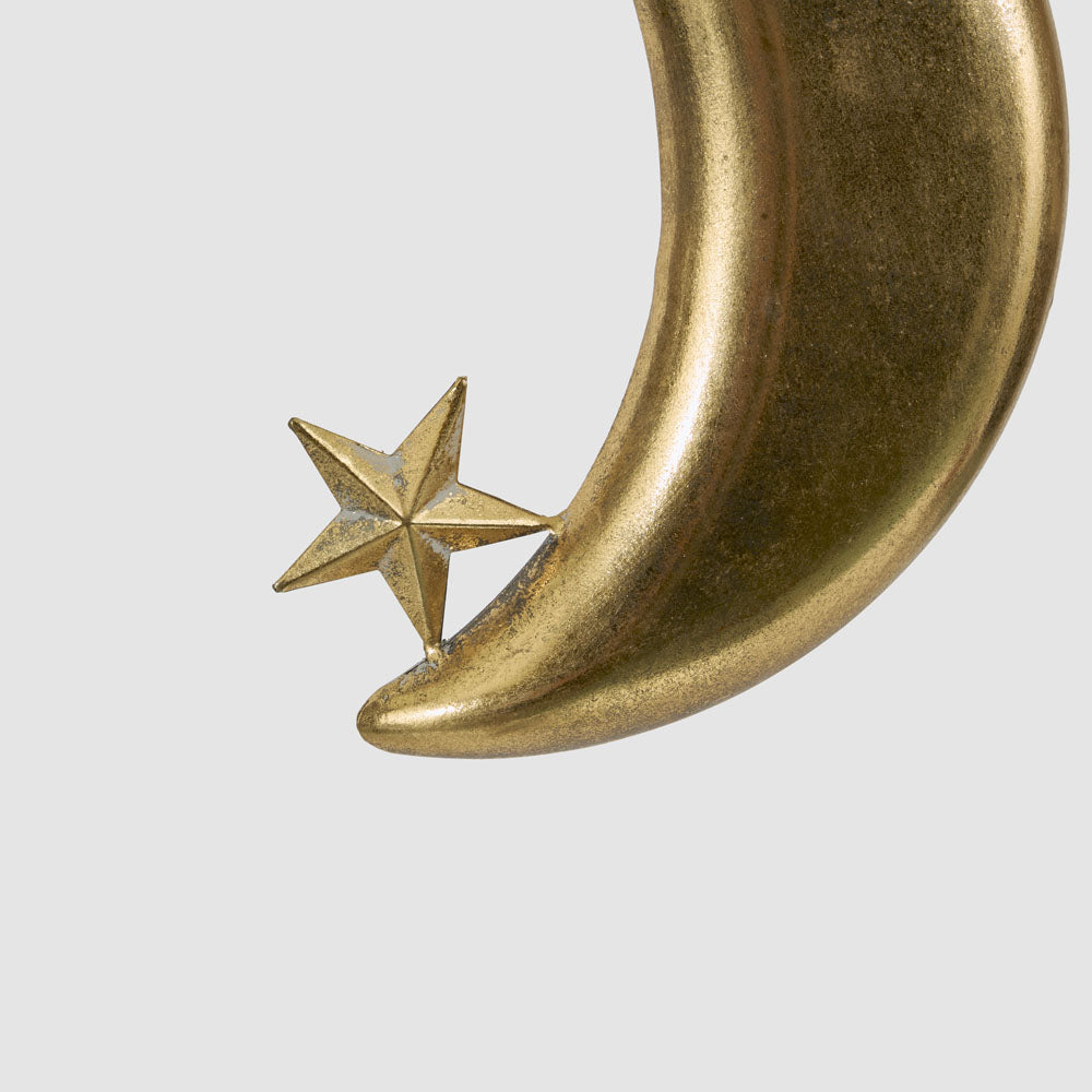 Small gold crescent moon hanging decoration close-up showing the faceted star and textured gold crescent