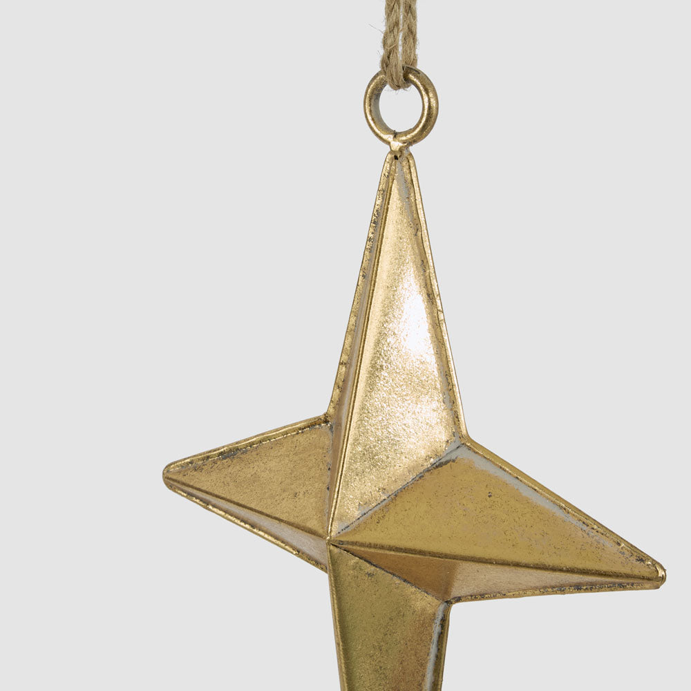 Small gold metal star hanging decoration close-up showing its textured gold finish and raised centre
