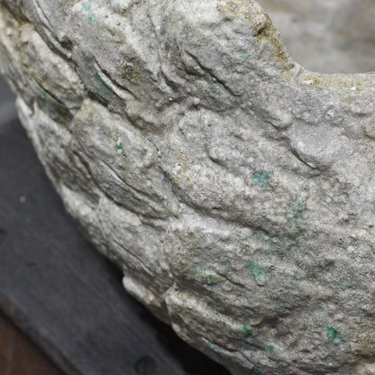 Close-up of moulded feather detail and aged finish on cement swan planter