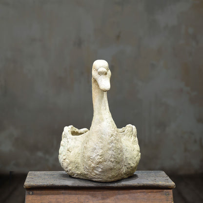 Front view of cement swan planter with upright curved neck