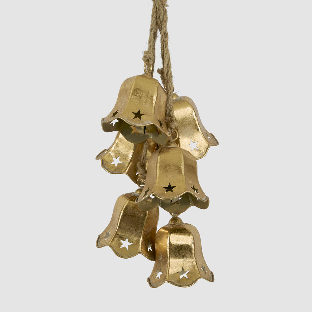 Bunch of gold flower-shaped bells with star cut-outs hanging from natural cords
