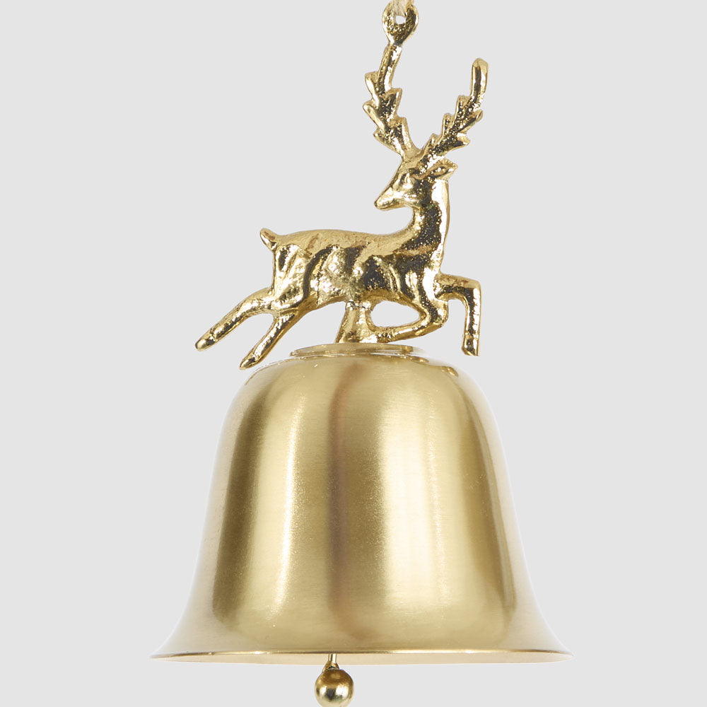 Close-up of the gold reindeer figure above the smooth gold bell