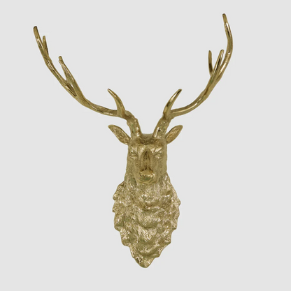 Angled view of a gold-coloured wall-mounted deer head with branching antlers and textured fur detail