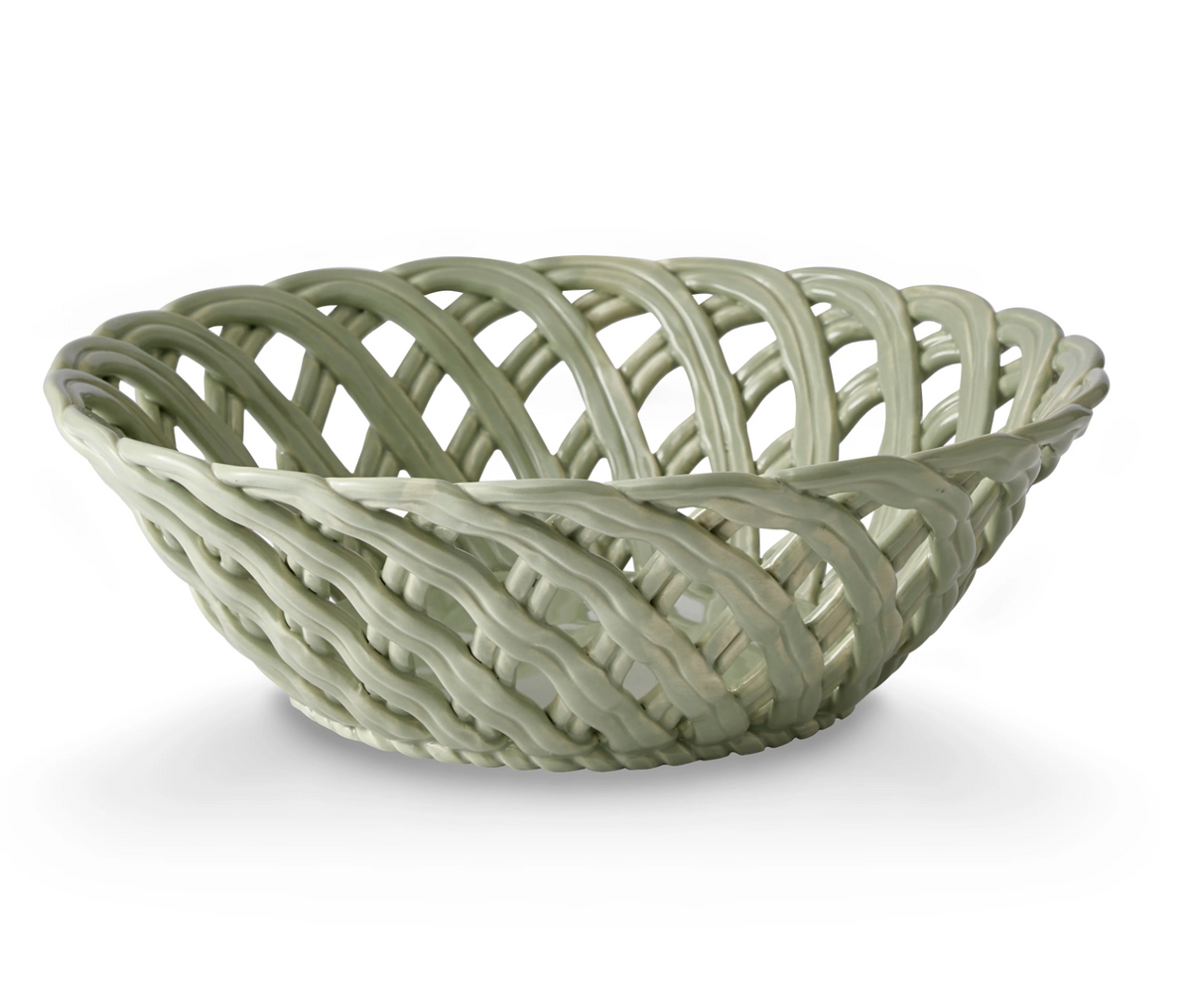 Light green ceramic bowl with an open woven lattice design on a white background