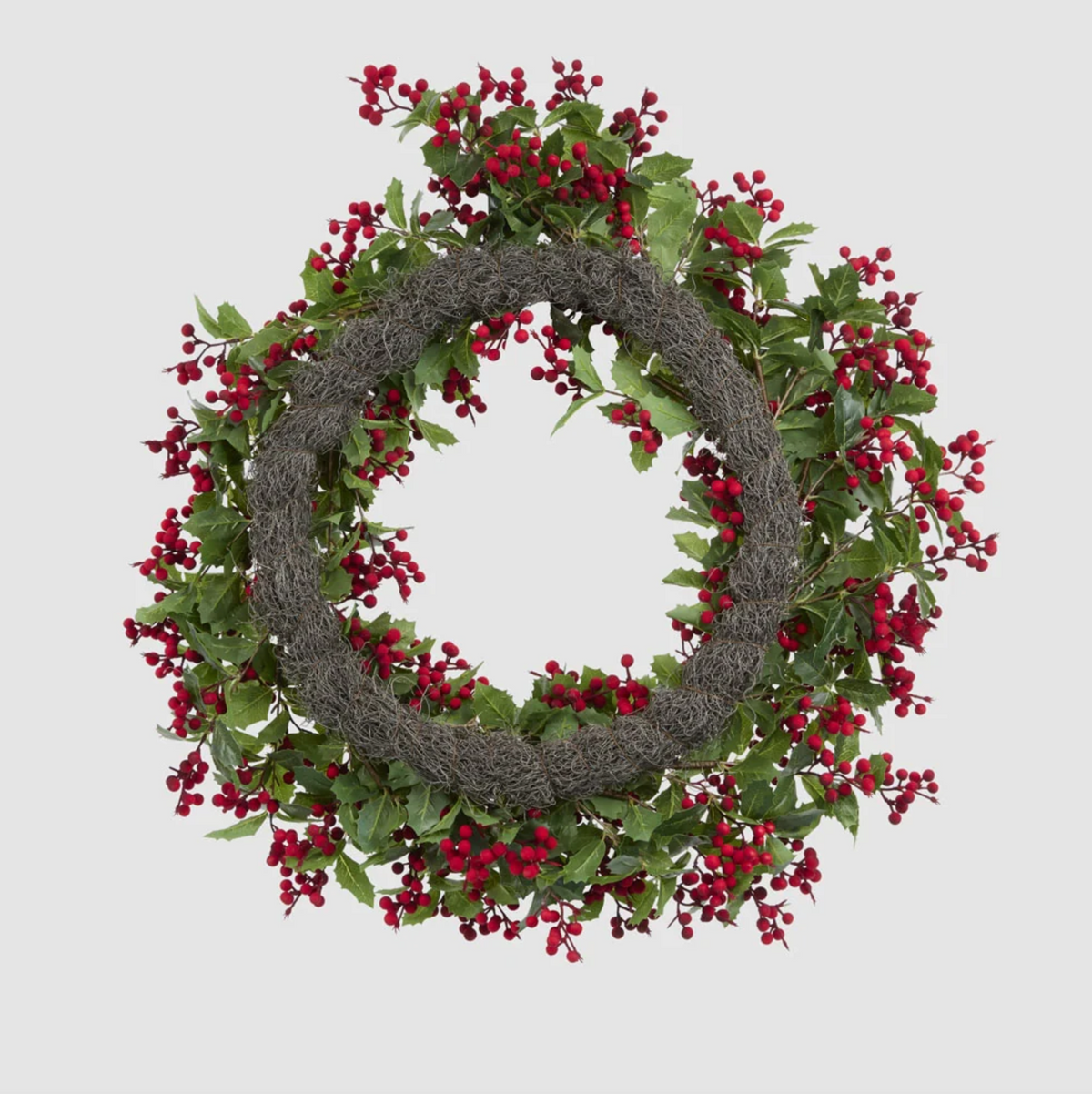 Back view of the holly and red berry wreath showing its circular backing