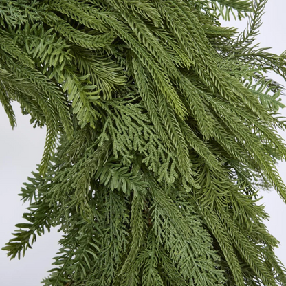 Close-up of the mixed cypress wreath showing its varied green foliage textures