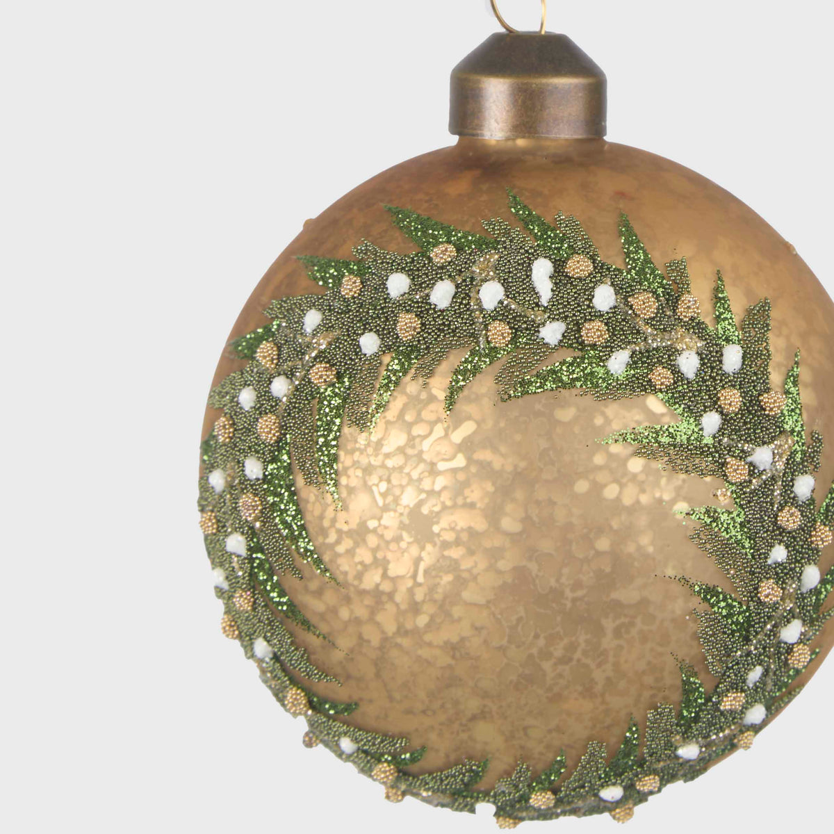 Close-up of the gold glass bauble showing glittered green foliage and white and gold berry details