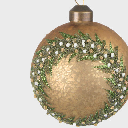 Close-up of the gold glass bauble showing glittered green foliage and white and gold berry details