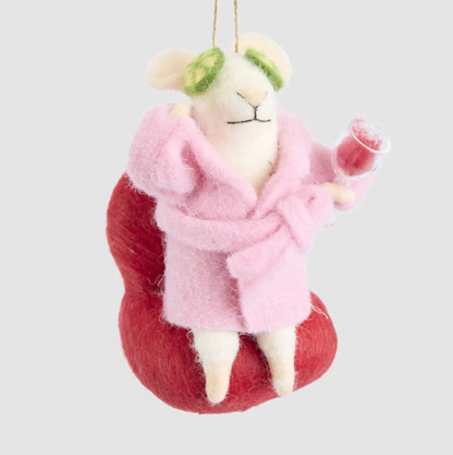 Front view of the pampered mouse decoration showing its pink belted dressing gown, red chair and raised wine glass