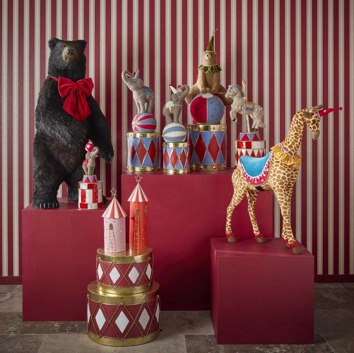 Pink tent in a festive display with a red tent, bear and other decorative animal figures