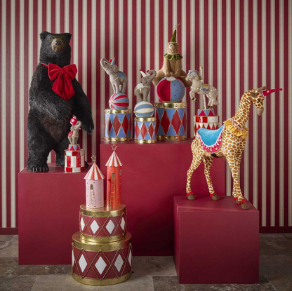 Pink tent in a festive display with a red tent, bear and other decorative animal figures