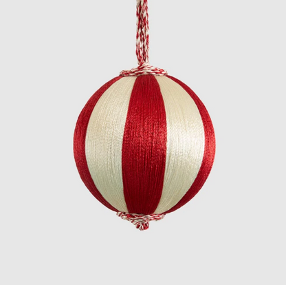 Small red and ivory striped bauble hanging from a twisted cord