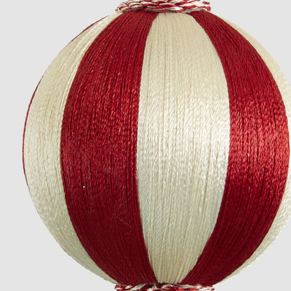 Close-up of the small bauble showing red and ivory thread-textured stripes