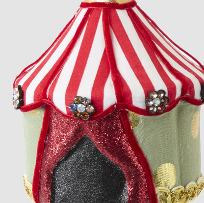 Close-up of the tent decoration showing striped roof, flower-shaped jewel details and gold-coloured trim